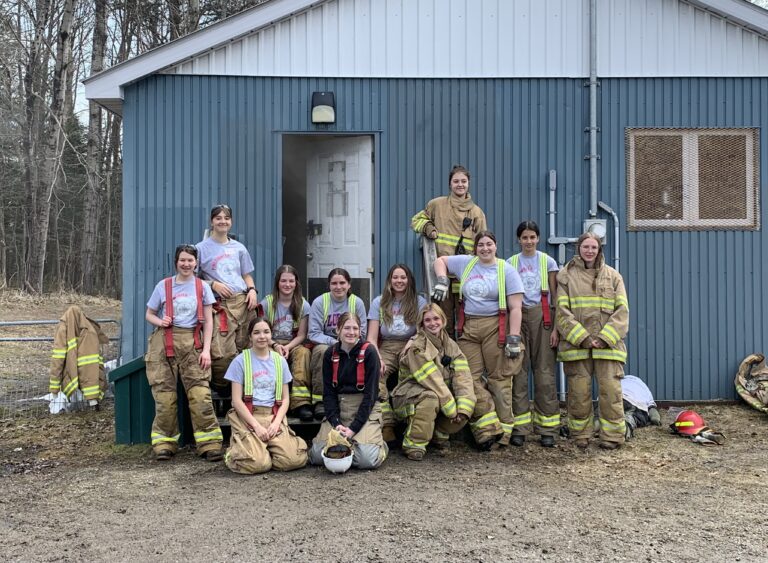 Female students learning more about a career in firefighting