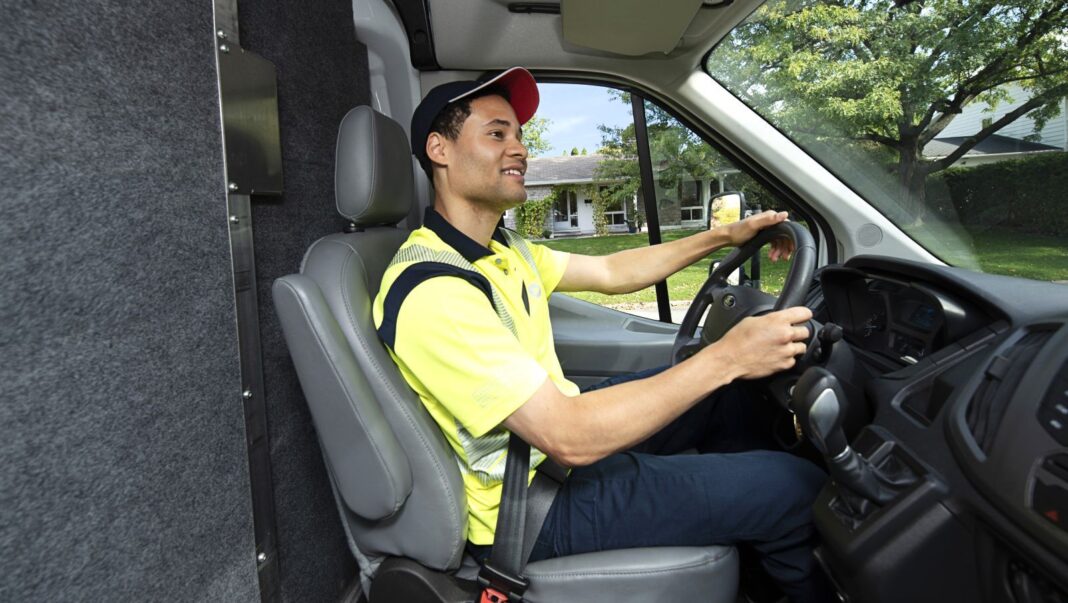 Delivery agent driving a mail delivery truck. | Canada Post photo